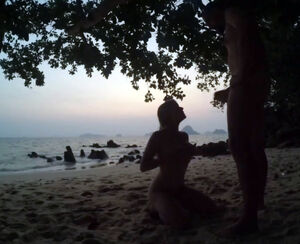 Russian little girl gargle on public beach after sunset