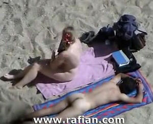 African and milky gals sunbathing on naked beach